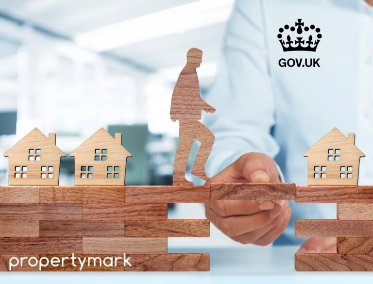 Wooden figure crossing houses on wooden blocks symbolising government support for landlords.