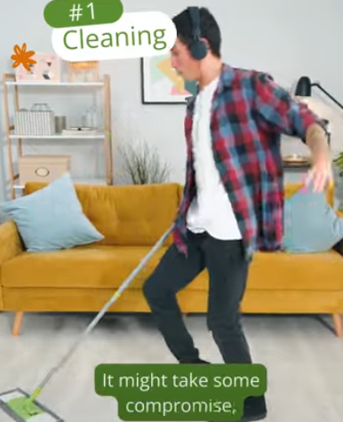 Student listening to music while cleaning living room with mop