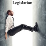 Businessman trapped between two walls symbolizing landlords under pressure from new property legislation