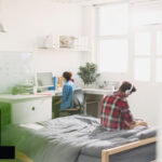 Students studying in a bright shared accommodation room in London