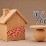 Wooden house with “Update” stamp beside percentage symbol representing mortgage rate changes.