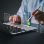 Person using laptop with digital rental documents and approval checkmark