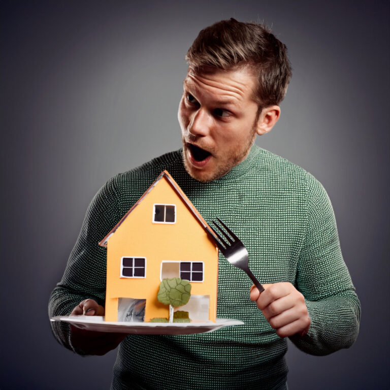 Man holding a model house on a plate with a fork, symbolizing buy-to-let landlord confidence.