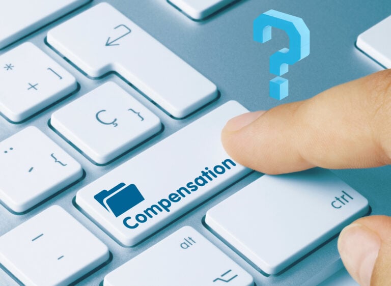 Finger pressing a keyboard key labeled “Compensation” with a question mark above.