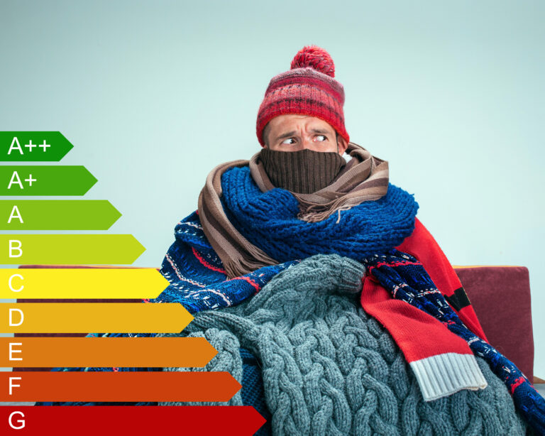 Person bundled in layers of clothing with energy efficiency scale beside them, highlighting fuel poverty.