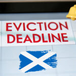 Eviction deadline reminder in Scotland with warning symbol and Scottish flag