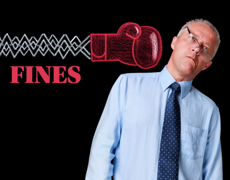 Businessman hit by symbolic boxing glove labeled fines, representing penalties on letting agencies