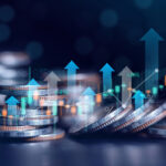 Stacks of coins with rising financial graphs and growth arrows