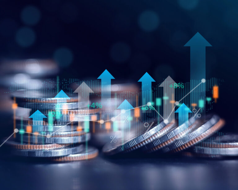 Stacks of coins with rising financial graphs and growth arrows