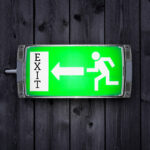 Green exit sign symbolizing landlords leaving the rental market
