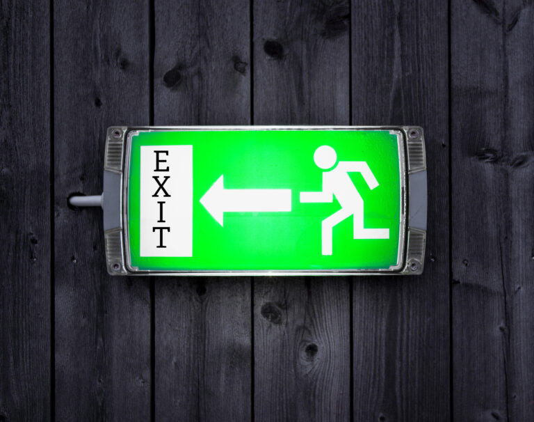 Green exit sign symbolizing landlords leaving the rental market