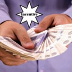 Hands holding a large stack of cash with the word "Incentive" above.