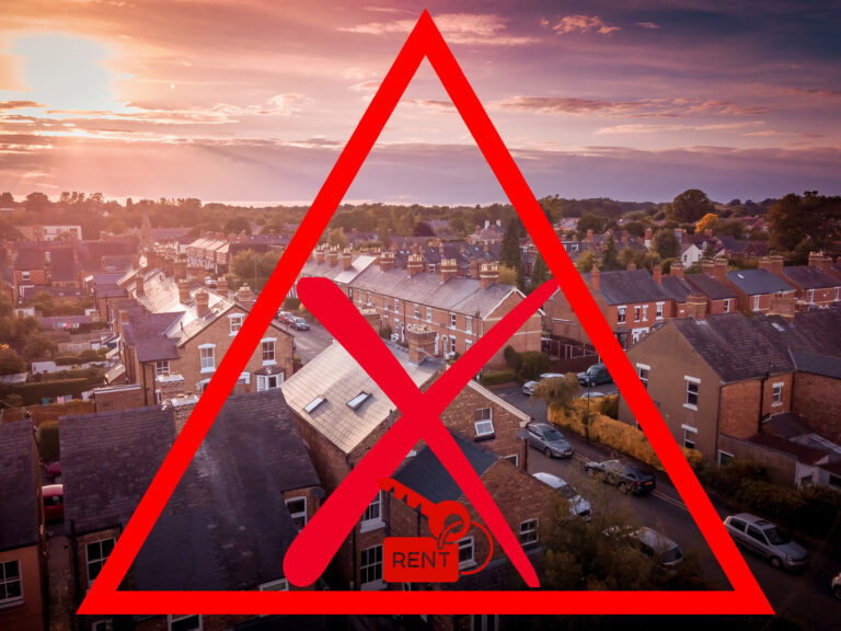 Suburban UK housing with red warning symbol highlighting rental crisis
