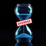 Hourglass with blue sand and overdue stamp symbolizing eviction delays