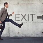 Landlord walking away with briefcase marked PRS toward exit sign