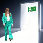 Angela Rayner walking toward an exit doorway after resignation as Housing Secretary