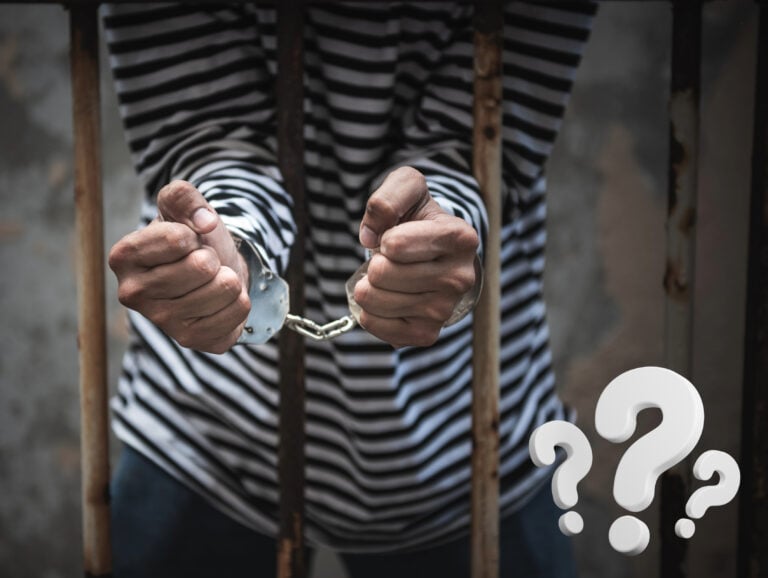 Prisoner behind bars with handcuffs, symbolizing legal uncertainty in eviction process