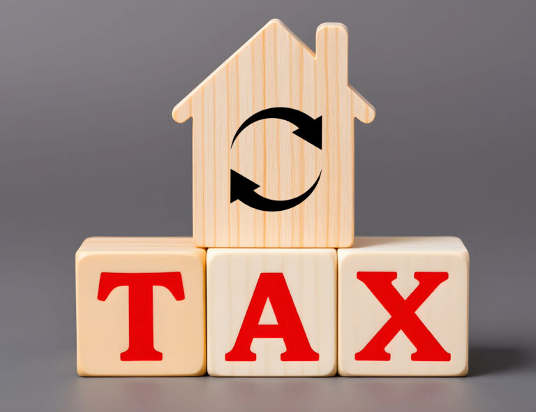 House-shaped block with tax letters symbolizing property tax reform