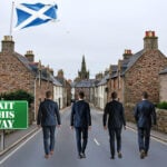 Four men in suits walk toward a Scottish town under a flag, symbolizing landlords leaving Scotland.