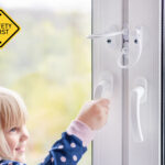 Child trying to open window with safety restrictors installed