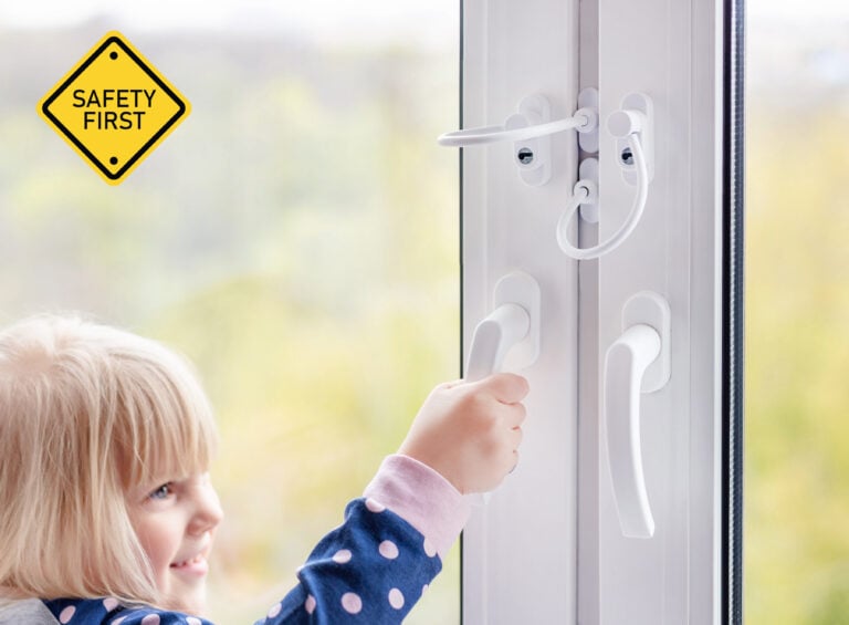 Child trying to open window with safety restrictors installed