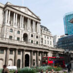 Bank of England building with red London bus in front, symbolising UK property and financial markets