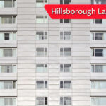 High-rise building with campaign banner promoting Hillsborough Law for cladding scandal justice