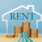 Stacked coins with rising arrows symbolizing increasing UK rental costs