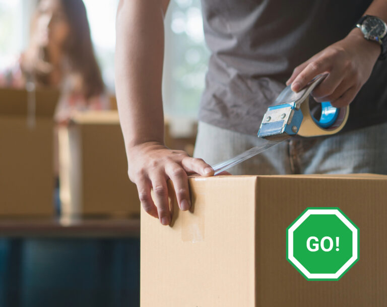 Person sealing a moving box with tape, symbolizing tenants moving out early.
