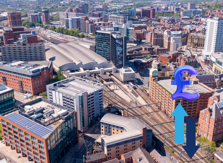 Aerial view of city buildings and train station with pound symbol and arrows showing property price trends near stations