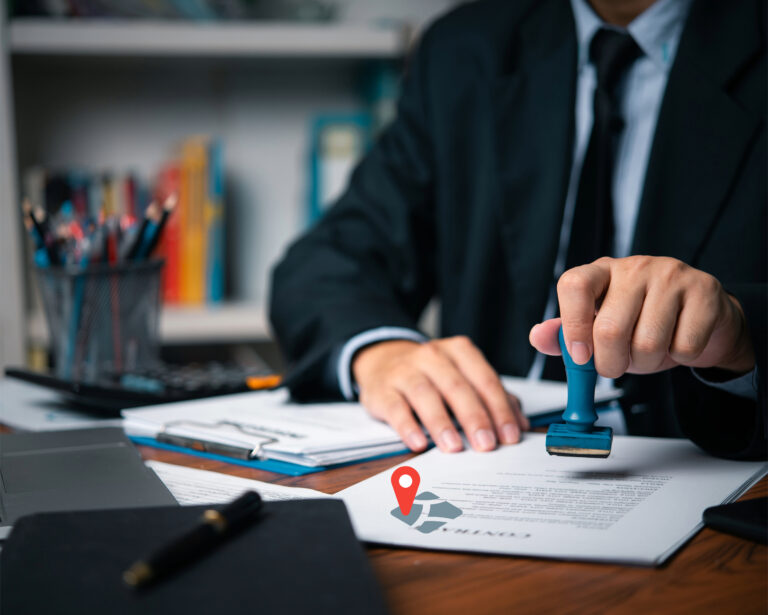 Official stamping housing licence documents on a desk, representing landlord licensing policy.