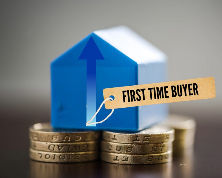 Model house on coins with “First Time Buyer” tag symbolising rising property costs