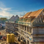 New housing development under construction in London with scaffolding and timber roofs
