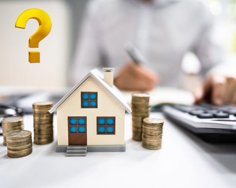 Model house with coin stacks and calculator symbolizing buy-to-let investment decisions