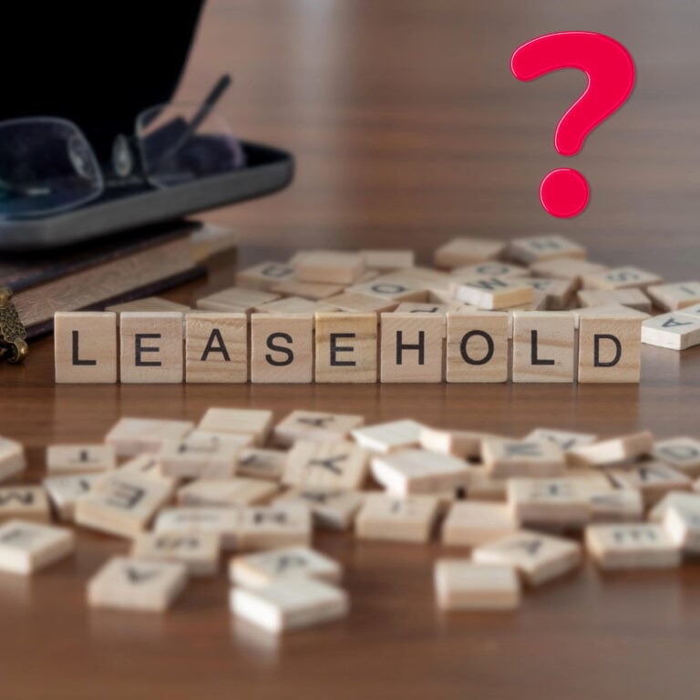 Wooden letter tiles spelling “leasehold” beside a red question mark, symbolising confusion about property ownership.