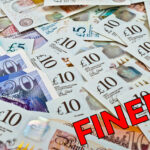 Pile of British pound notes with the word “FINED” symbolising landlord penalties in Hounslow.