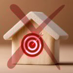 Wooden house with a red target symbol crossed out, representing missed housing targets.