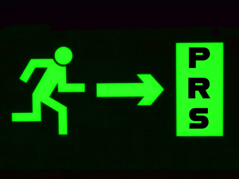 Green exit sign symbolising landlords leaving the private rented sector amid housing shortages