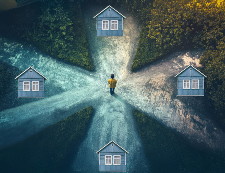 Person standing at a crossroads choosing between different housing paths.