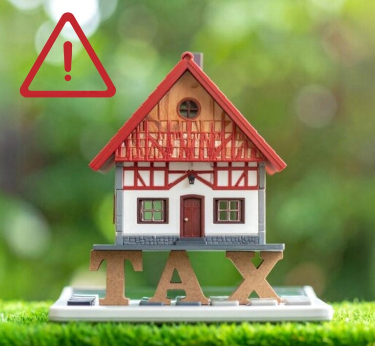 Model house on calculator with tax warning symbol, representing property tax reform concerns