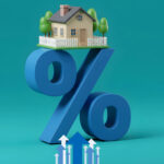 Small house balanced on a large blue percent symbol representing rising UK mortgage rates