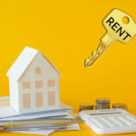 Model house, coins, and calculator symbolizing rising rental values and property market trends.
