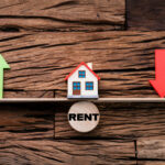 Model house balancing between rising and falling rent prices.