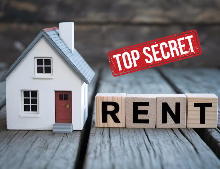 Model house beside wooden blocks spelling rent with top secret stamp.