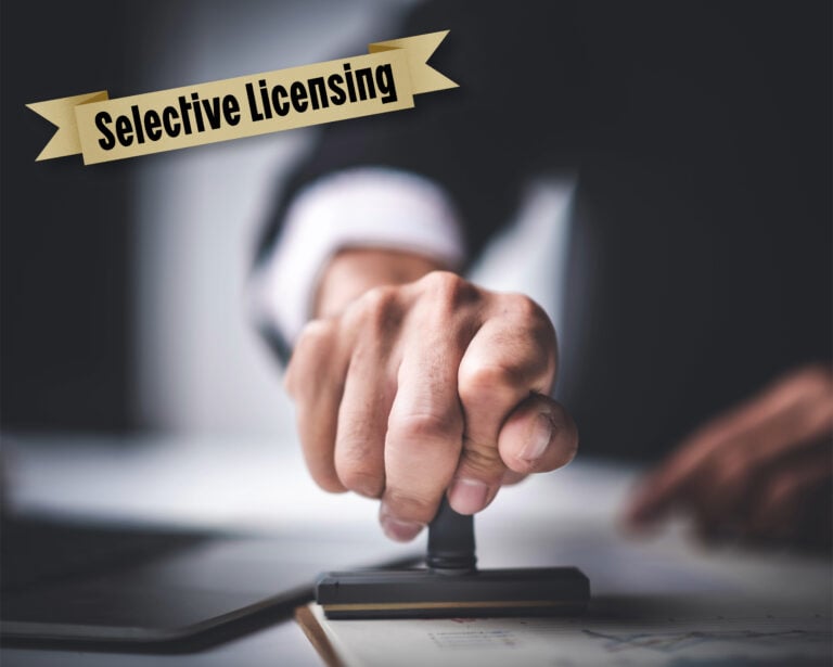 Hand stamping document symbolising approval of Leeds selective licensing scheme