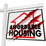Affordable housing sign with claw marks symbolizing cuts to housing targets