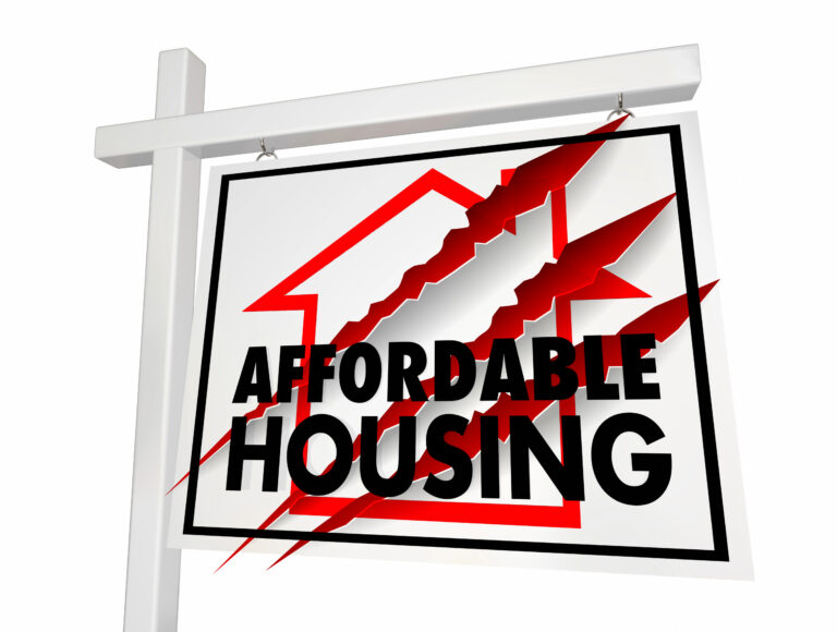 Affordable housing sign with claw marks symbolizing cuts to housing targets