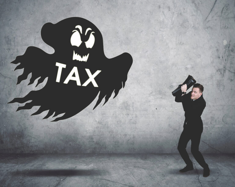 Businessman facing a ghost labeled “TAX,” symbolizing fear of new landlord taxes