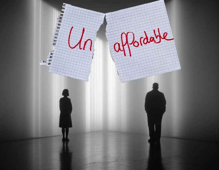 Concept image showing housing unaffordability with two people separated under torn paper reading “Un-affordable”