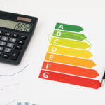 Energy efficiency rating chart with calculator and pen, highlighting EPC band C.